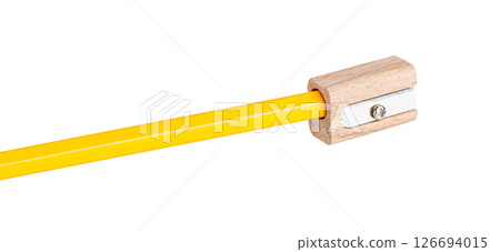 wooden pencil sharpener with a yellow pencil on white isolated backdrop. Perfect for school supplies, office, and art needs. 126694015