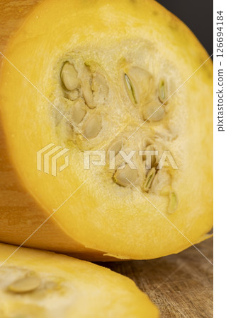pumpkin or zucchini, slicing ripe zucchini on a black cooking table, close up 126694184
