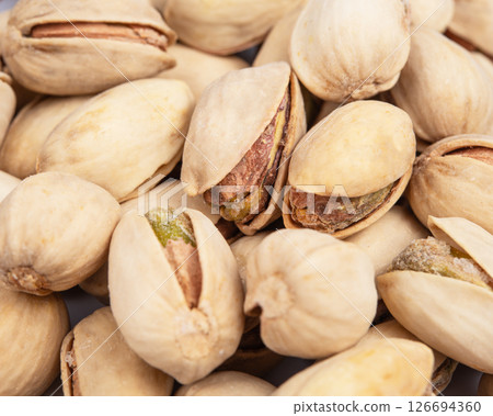 View close-up on a group of salted pistachio nuts with shallow depth of field 126694360