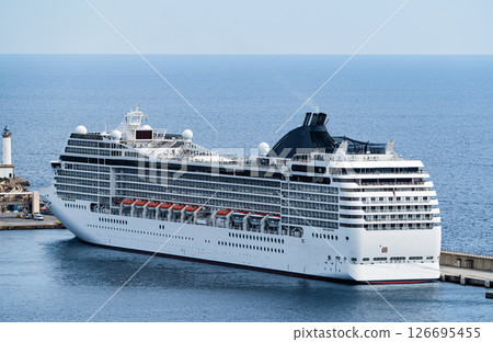 Modern Cruise Ship Docked at Port by the Sea Modern Cruise Ship Docked at Port by the Sea 126695455
