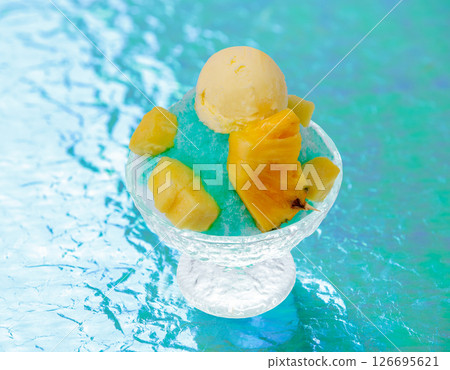 Cold summer shaved ice dessert (pineapple ice cream) 126695621