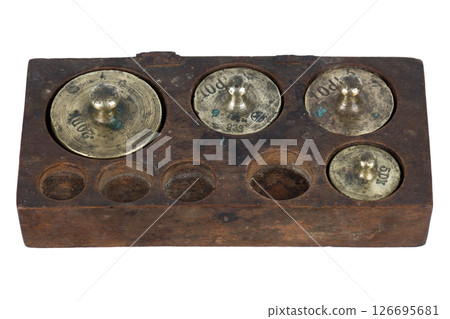 Vintage wooden box with scale weights set on white 126695681