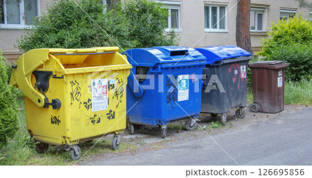 Nitra, Slovakia - 05.21.2025: Garbage bins on the street. Caring for the environment, sorting garbage into different containers. Close-up. 126695856