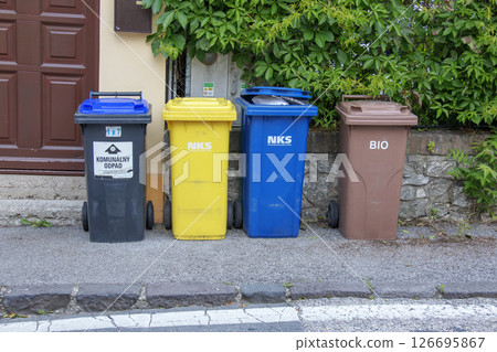 Nitra, Slovakia - 05.21.2025: Different colored bins for collecting materials for recycling. Nitra, Slovakia - 05.21.2025: Different colored bins for collecting materials for recycling. 126695867