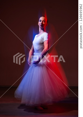 Caucasian woman dancing classical dance in tutu . Long exposure photo.  126695962
