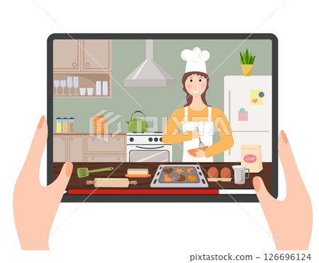 Cooking courses online. Chef gives a step-by-step lesson. Hands holding a tablet with an online show. View of a kitchen with a chef and baking ingredients. Cooking at home, time with family, home Cooking courses online. Chef gives a step-by-step lesson. Hands holding a tablet with an online show. View of a kitchen with a chef and baking ingredients. Cooking at home, time with family, home 126696124