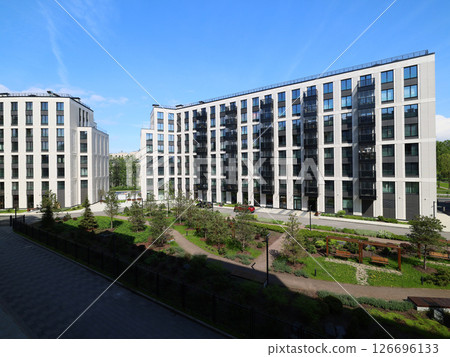 A Modern Residential Complex Featuring Lush Green Surroundings and Scenic City Views A Modern Residential Complex Featuring Lush Green Surroundings and Scenic City Views 126696133