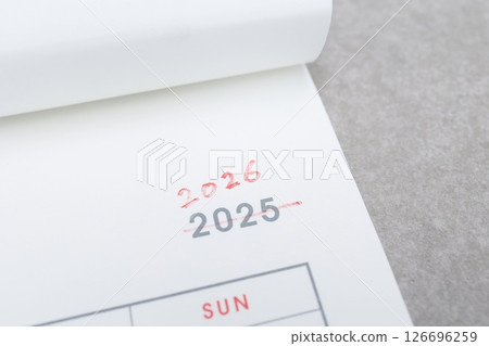 Cross out the 2025 on the calendar and change it to 2026 in red pen 126696259
