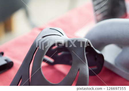 Black Costume Face Mask printed on 3D printer from plastic. An object created on a 3D printer from sintered plastic powder. New modern additive technologies. 3D Printing technology Black Costume Face Mask printed on 3D printer from plastic. An object created on a 3D printer from sintered plastic powder. New modern additive technologies. 3D Printing technology 126697355