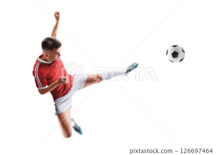 Soccer action. Young professional footballer in motion, strong kick on the ball. Focus on the kick. Isolated 126697464
