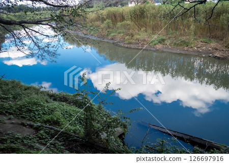 Blue sky and white clouds reflected on the water surface 126697916