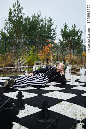 A surreal chessboard scene featuring a person in a strikingly striped outfit and vibrant colors A surreal chessboard scene featuring a person in a strikingly striped outfit and vibrant colors 126698272