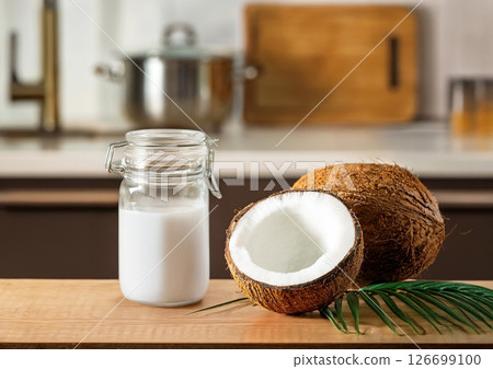 Coconut milk and coconuts in a jar 126699100