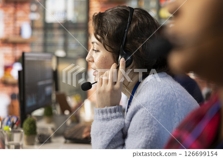 Call center agent using remote access tools to connect to customer devices remotely for troubleshooting. Close up of customer center worker assisting users with installing software Call center agent using remote access tools to connect to customer devices remotely for troubleshooting. Close up of customer center worker assisting users with installing software 126699154
