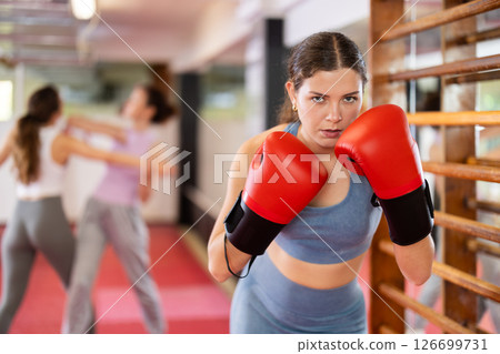 Woman with boxing gloves learning punches 126699731