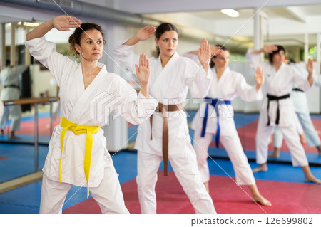 Group of womens practicing martial arts in gym. Active lifestyle and self defense concept 126699802