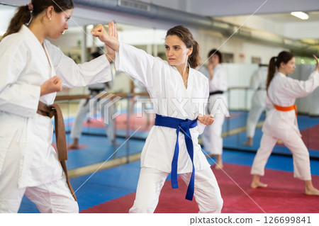 Women pupils train to perform defensive karate installations and attacking combat techniques Women pupils train to perform defensive karate installations and attacking combat techniques 126699841