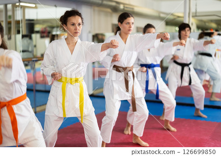 Group of womens practicing martial arts in gym. Active lifestyle and self defense concept 126699850