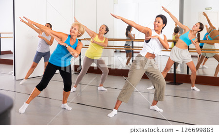 Modern active females dancing excited posing in studio Modern active females dancing excited posing in studio 126699883