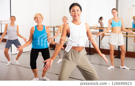 Group of happy women different ages practicing zumba in dance class 126699923
