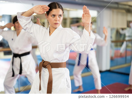 Women in self-defense training in white kimono with belts 126699934