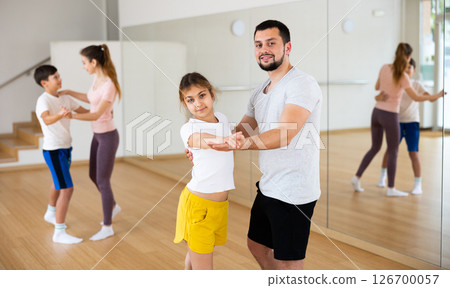 Dad and young daughter learning to dance waltz together 126700057