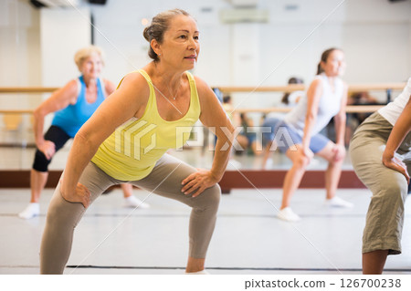 Old lady dancing with group in studio Old lady dancing with group in studio 126700238