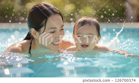 Smiling parents and children playing in the pool 126700374