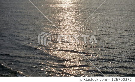 A path of light on the sea in the evening A path of light on the sea in the evening 126700375