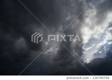 Dramatic dark storm thundercloud rain clouds on black sky background. Dark thunderstorm clouds rainny landscape. Meteorology danger windstorm disaster climate. Dark cloudscape storm disaster gray sky 126700780