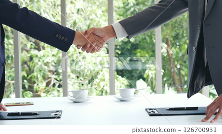 Team Business Partners shaking hands together to Greeting Start up new project. Shakehand Teamwork Partnership at office desk. Businessman partners handshake together.  Business concept 126700931