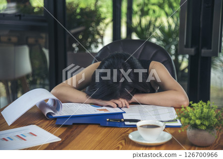Desperate Asian woman stress headache depressed from startup small business at home office. Failure business woman work at home office. Online seller entrepreneur has problem delivery unhappy job 126700966