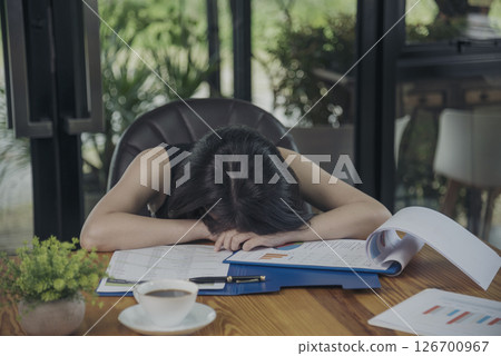 Desperate Asian woman stress headache depressed from startup small business at home office. Failure business woman work at home office. Online seller entrepreneur has problem delivery unhappy job 126700967