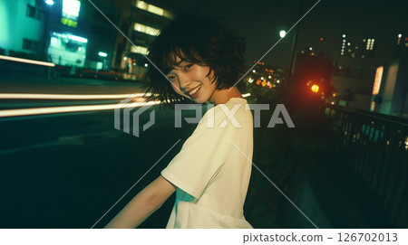 Young woman walking in the city at night 126702013