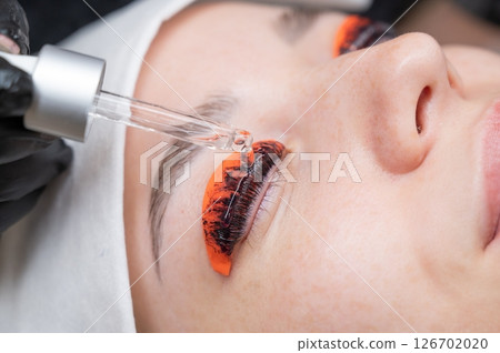 The process of professional lamination and tinting of eyelashes in the salon. 126702020