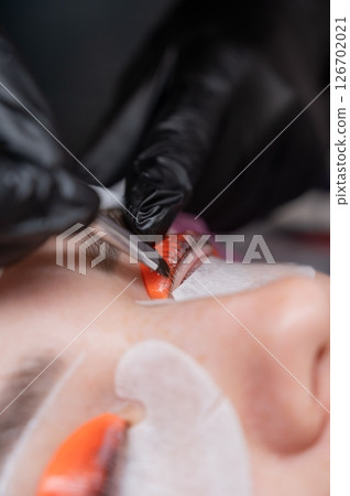 The process of professional lamination and tinting of eyelashes in the salon. The process of professional lamination and tinting of eyelashes in the salon. 126702021