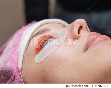 The process of professional lamination and tinting of eyelashes in the salon. 126702024