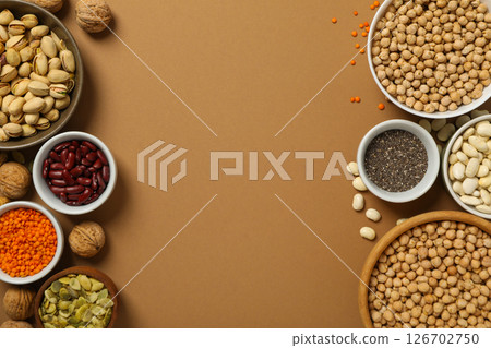 Beans, nuts and seeds in bowls on beige background, space for text Beans, nuts and seeds in bowls on beige background, space for text 126702750