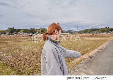 Woman gazing into the distance in nature Woman gazing into the distance in nature 126703392