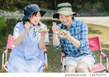 Camping couple eating curry 126703575