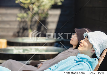 Men and women enjoying sauna Men and women enjoying sauna 126703591