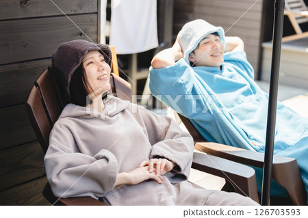 Men and women enjoying sauna Men and women enjoying sauna 126703593