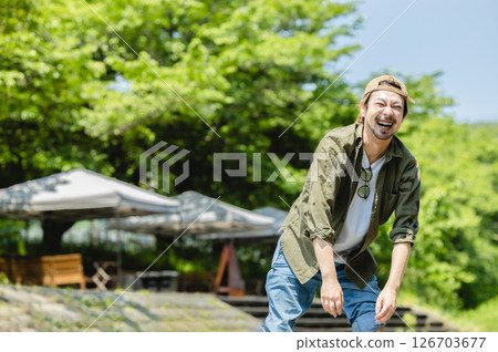 Camping: Men playing in the river 126703677