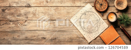Exploring astrology with charts a pendulum candle and notebook on a rustic wooden desk 126704589