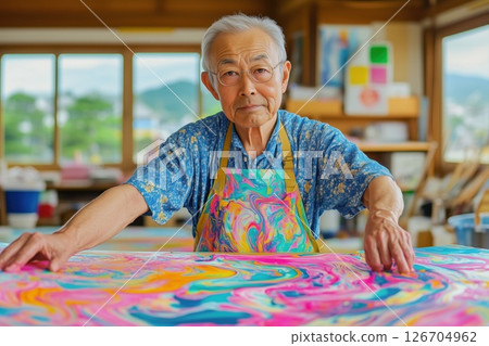 Experienced artist working on a colorful abstract painting in a bright studio setting 126704962