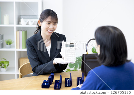 On-site purchase: A woman assessing an item 126705150