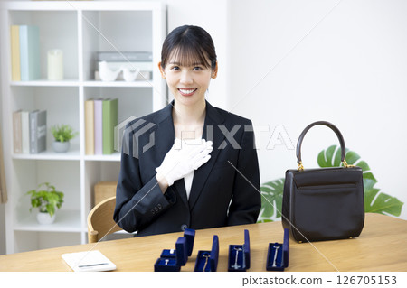 On-site purchase: A woman assessing an item 126705153