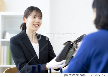 On-site purchase: A woman assessing an item 126705157