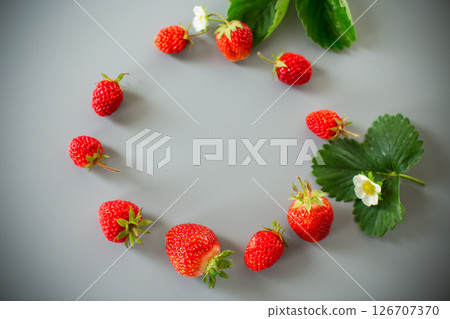 Juicy strawberries close-up on a gray background Juicy strawberries close-up on a gray background 126707370