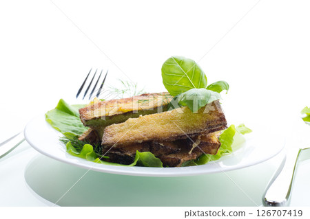 Golden fried zucchini on a white background Golden fried zucchini on a white background 126707419